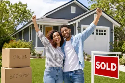 Happy couple celebrating sold home